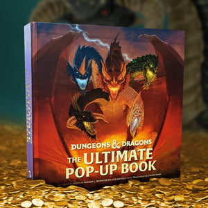 A book cover showing drawing of a multi-colored dragon with five heads, standing on a pile of gold coins. Behind the book is a blurry image of a green dragon. A single bolt of lighting is crossing the sky behind the dragon. At the bottom of the image is white text saying “Dungeons & Dragons: The Ultimate Pop-Up Book.”