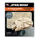 A box depicting the Millennium Falcon, with a wood model version next to it. Below the ship is a wood sheet with the model parts to be assembled. In the background is a field of stars.