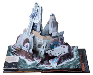 An image of a pop-up page from the book, on a white background. A white stone castle rises from the sea. Adventurers face off against various monsters throughout the castle.