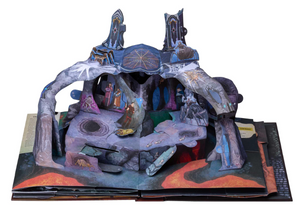 An image of a pop-up page from the book, on a white background. Purple rock formations with drawings of spiders and webs cover the surfaces of the rocks, and adventurers navigate their way through caverns and crevasses.